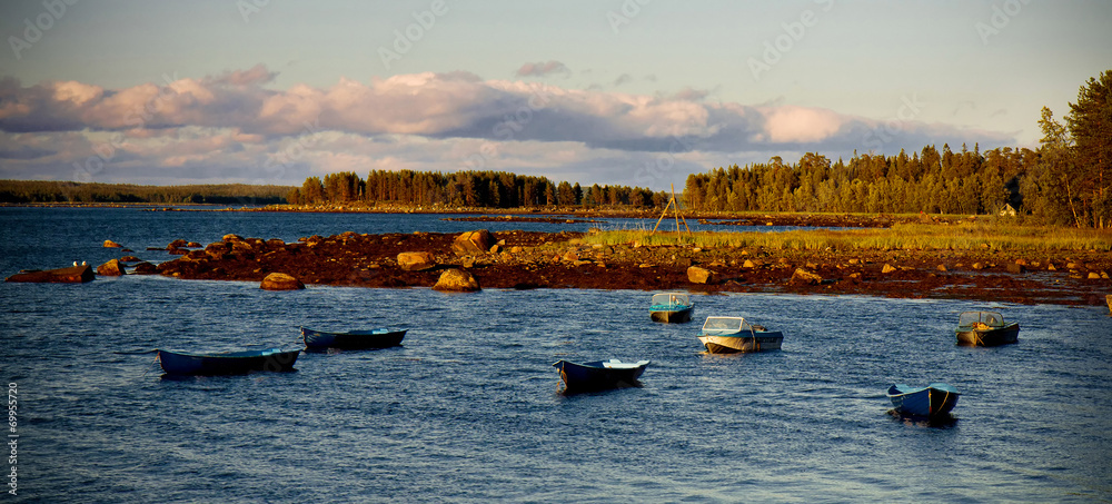 White Sea shore landscape with boats