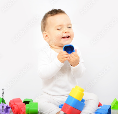 Beautiful baby girl with colorful toys - Studio shot