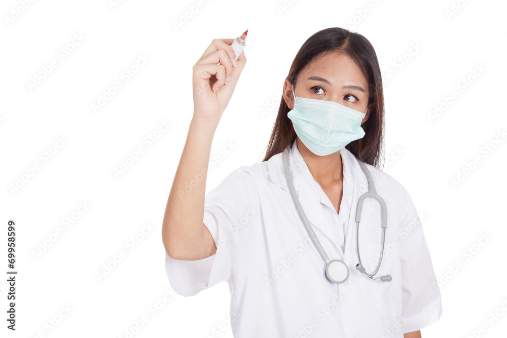 Young Asian female doctor with mask write with red marker Young Asian female doctor with mask write with red marker