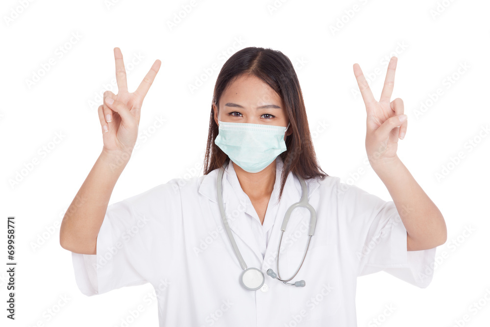 Young Asian female doctor show victory sign with both hands Young Asian female doctor show victory sign with both hands