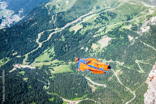 Obraz na płótnie BASE jumper jumping off a big cliff in Dolomites,Italy, breathta w salonie