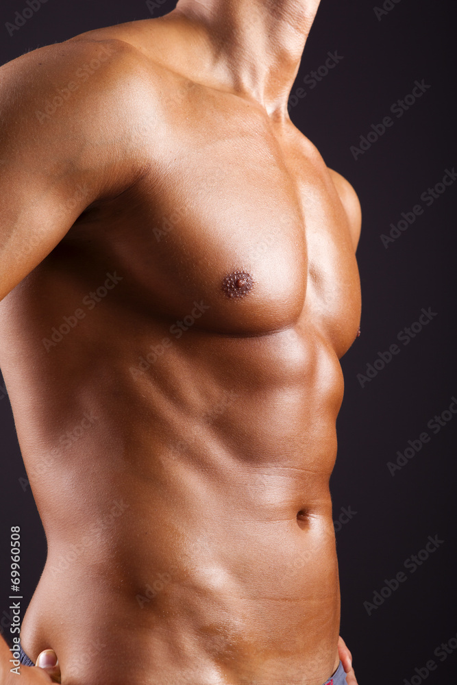 Beautiful man torso on black background