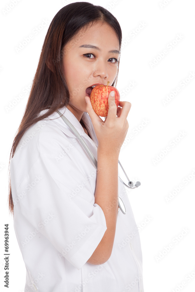 Young Asian female doctor bite apple Young Asian female doctor bite apple
