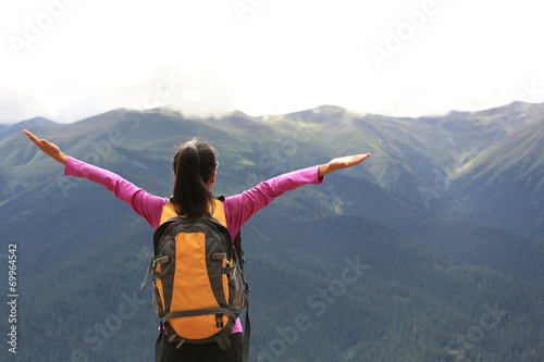 cheering young woman hiker enjoy the view mountain peak 