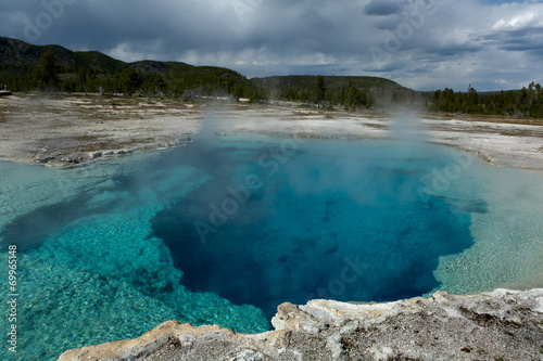 steamy blue post-volcanic pool in Yellowstone