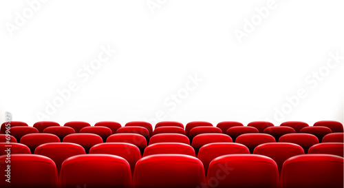 Rows of red cinema or theater seats in front of white blank scre