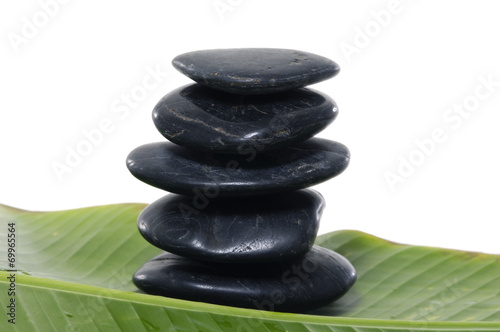 Stacked stones with green banana leaf