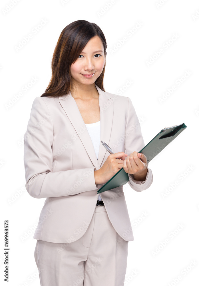 Asian businesswoman write on clipboard Asian businesswoman write on clipboard