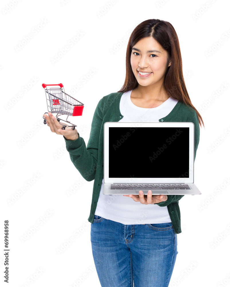 Woman show with laptop and small shopping cart Woman show with laptop and small shopping cart