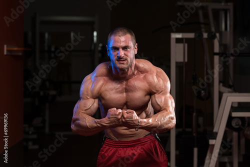 Young Bodybuilder Flexing Muscles © Jale Ibrak