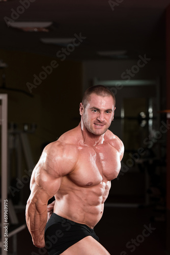 Bodybuilder Performing Side Triceps Pose