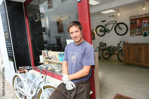 Business owner standing in front of shopwindow