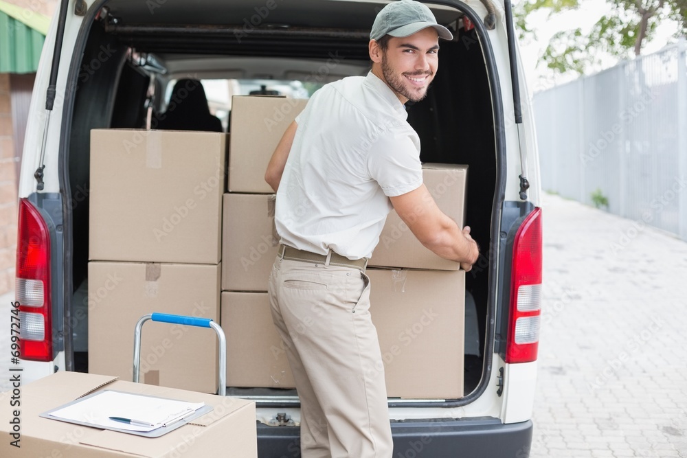 Delivery driver loading his van with boxes Delivery driver loading his van with boxes