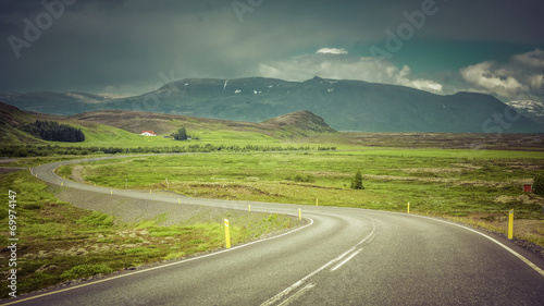 Curved asphalt road in high mountains of Iceland