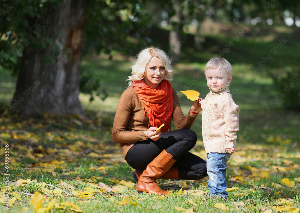 Mother and child having fun in autumn park Mother and child having fun in autumn park