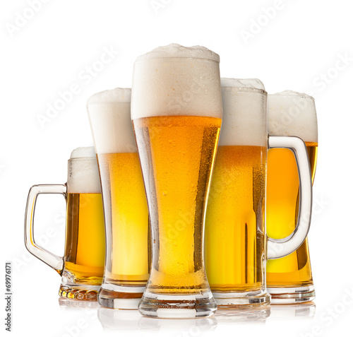 Collection of glasses of beer on white