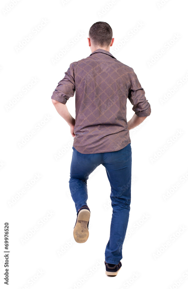 Back view of running man in brown shirt. Back view of running man in brown shirt.