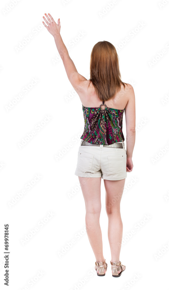 Fototapeta premium Back view of beautiful woman welcomes.