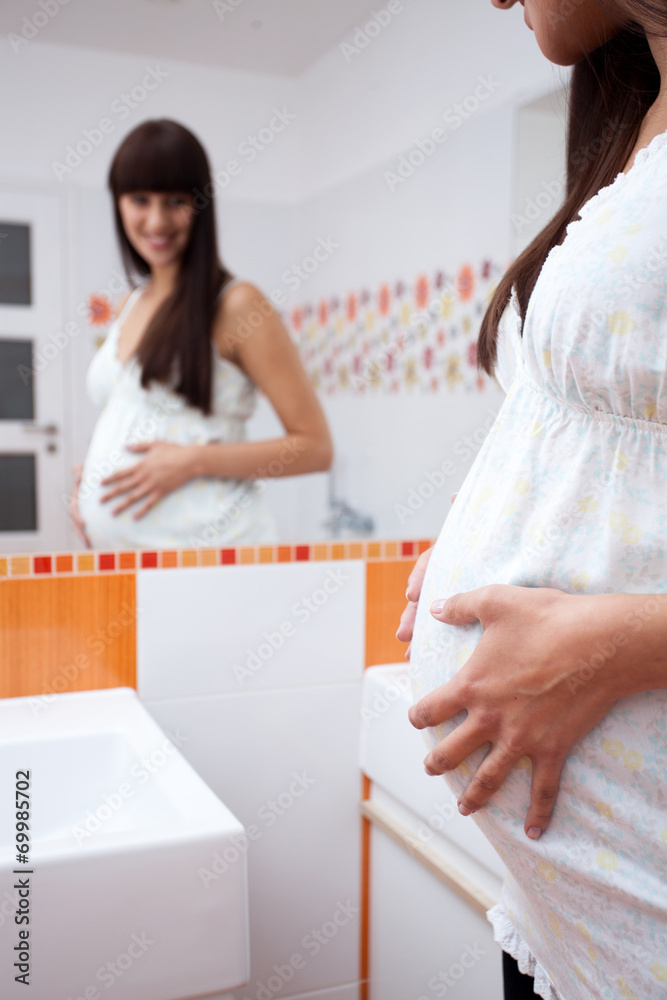 Smiling pregnant woman waiting for child Smiling pregnant woman waiting for child