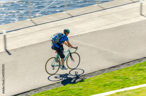 Commuter Riding a Bike on a Cycle Path photo