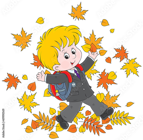 Schoolboy with autumn leaves