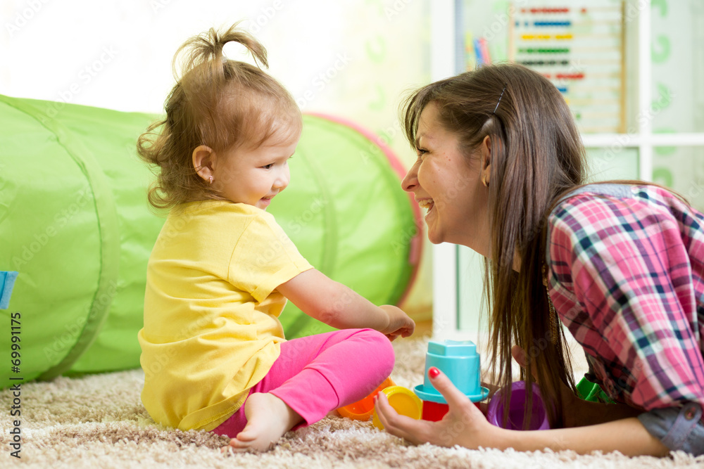 child girl and her mother playing together with toys child girl and her mother playing together with toys