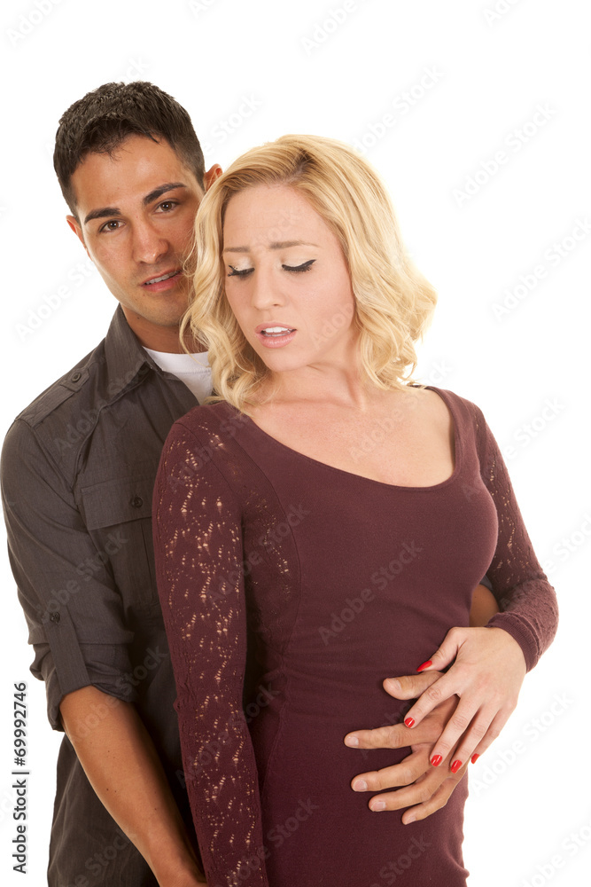 couple serious his arm around her waist couple serious his arm around her waist