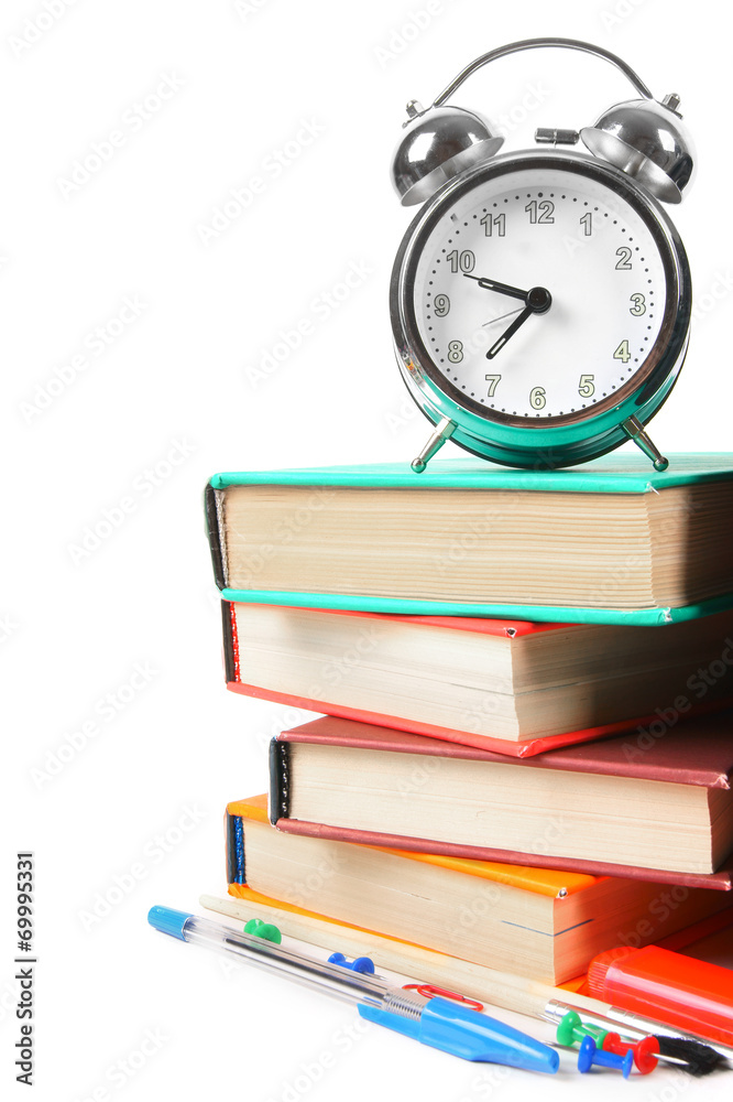 Books, an alarm clock and school tools. Books, an alarm clock and school tools.