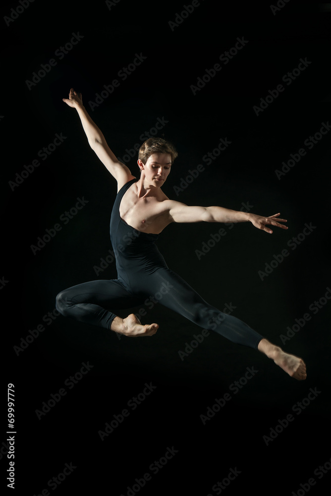 young ballet dancer dansing on black background