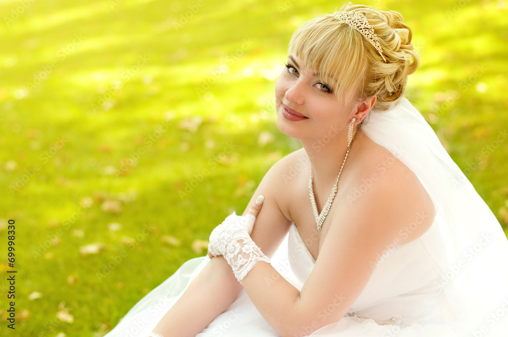 Beautiful bride with stylish make-up in white dress in garden Beautiful bride with stylish make-up in white dress in garden