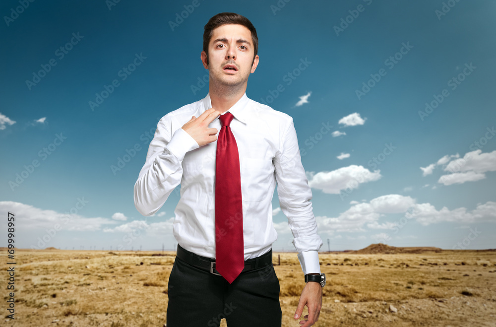 Fired businessman sweating in the desert Fired businessman sweating in the desert