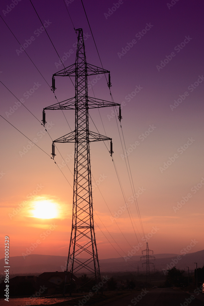 Electric tower at sunset with sun