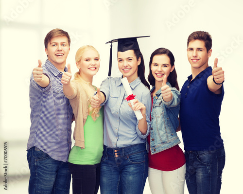 group of students with diploma showing thumbs up
