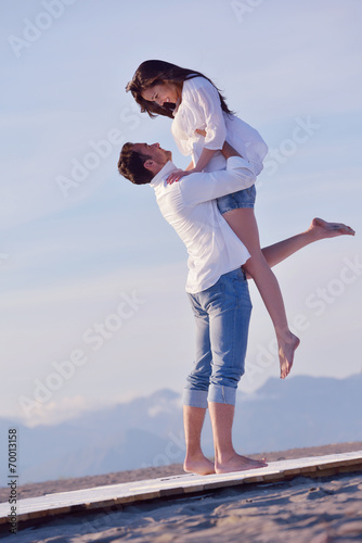 young couple on beach have fun