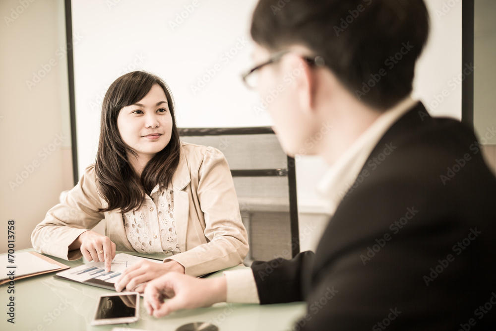 Successful young business executives meeting at the office Successful young business executives meeting at the office