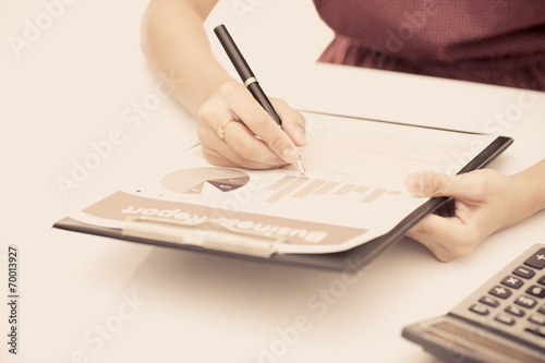 woman hand with pen and business report. Accounting