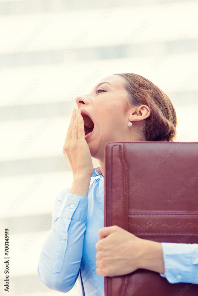 Fototapeta premium Sleepy young business woman, running to work yawning