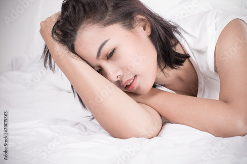 Portrait of a beautiful young woman in bed