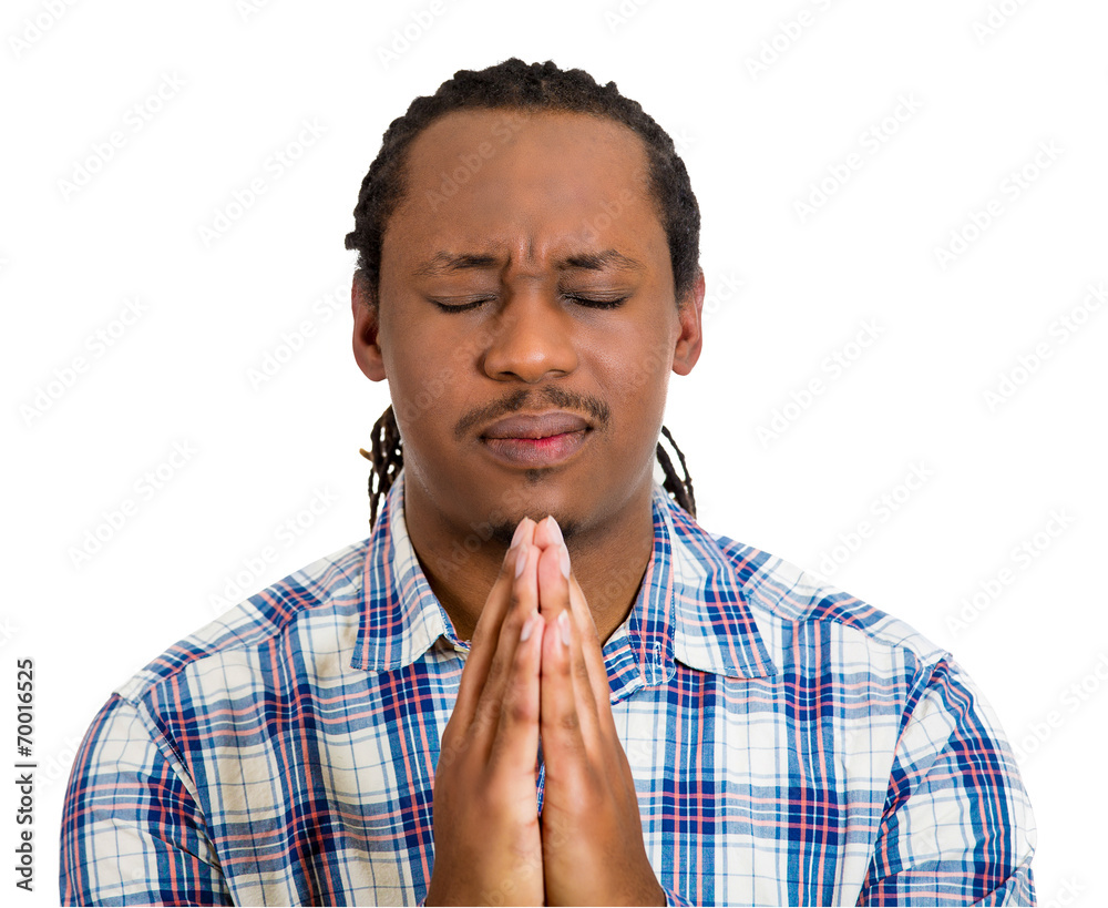 Young man praying hands clasped, hoping for best Young man praying hands clasped, hoping for best
