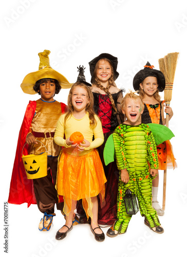 Kids with Halloween attributes in stage costumes