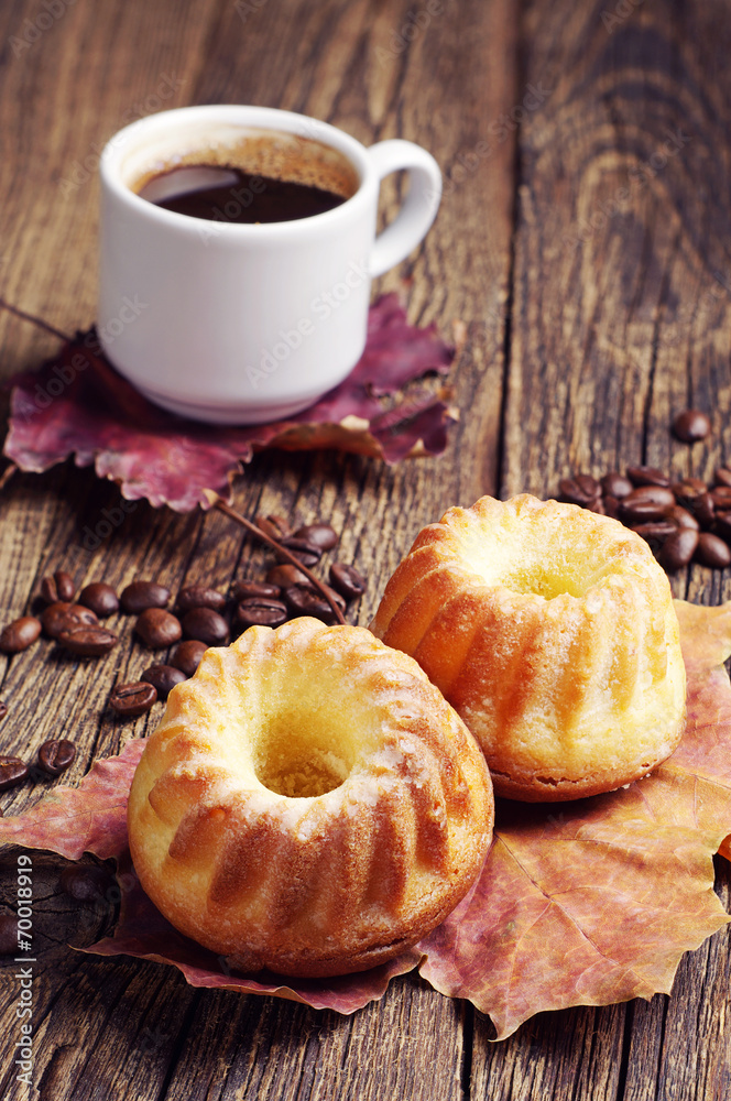 Two cupcake, coffee and autumn leaves Two cupcake, coffee and autumn leaves