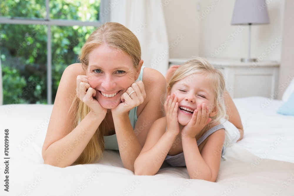 Cute little girl and mother on bed Cute little girl and mother on bed