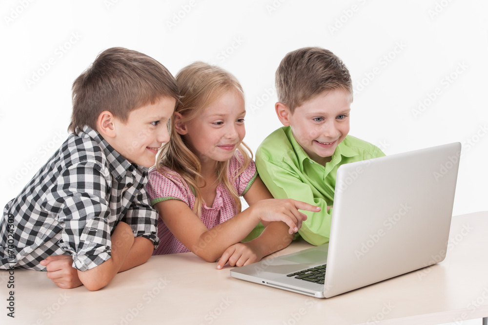Three kids using computer on white background.