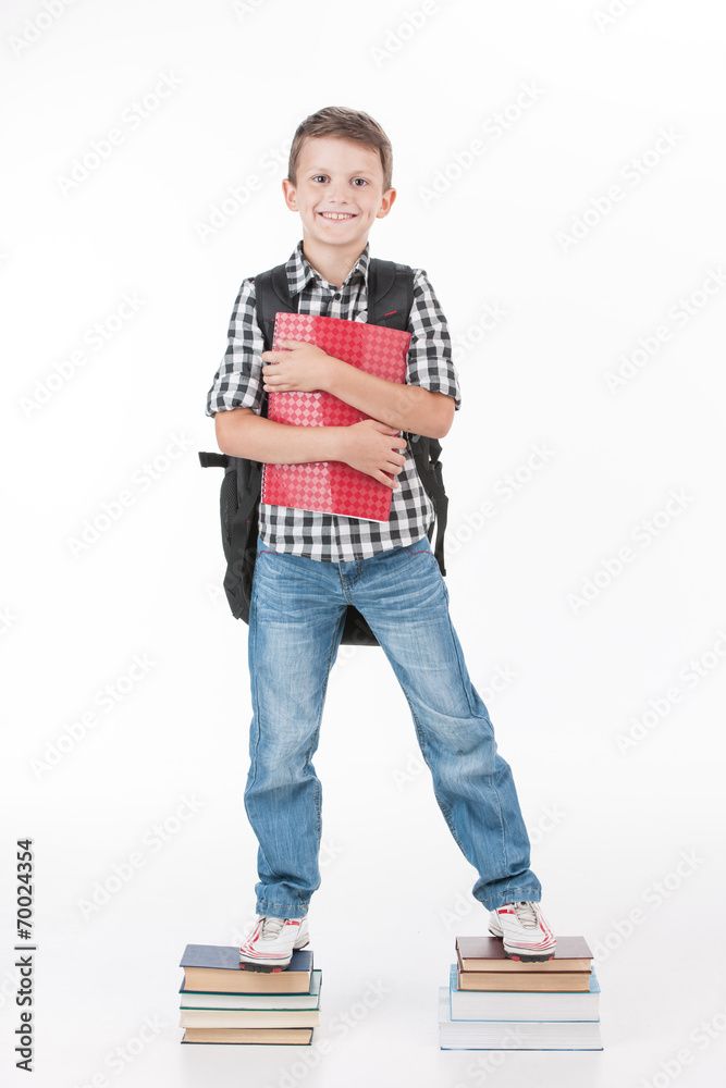 Happy schoolboy with notebook isolated on white background. Happy schoolboy with notebook isolated on white background.