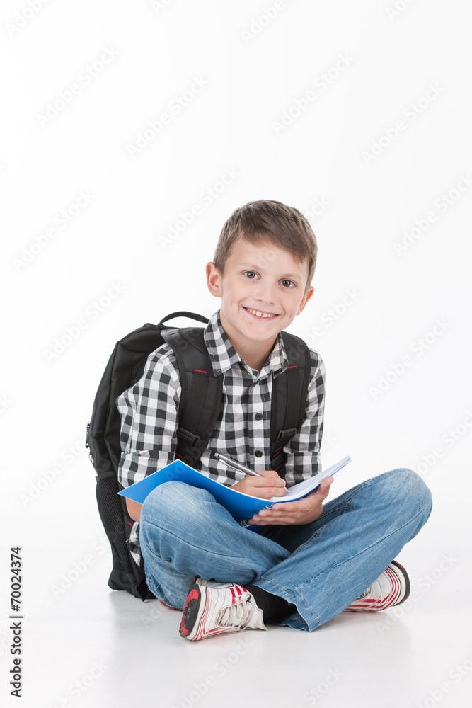 Happy schoolboy with notebook isolated on white background. Happy schoolboy with notebook isolated on white background.