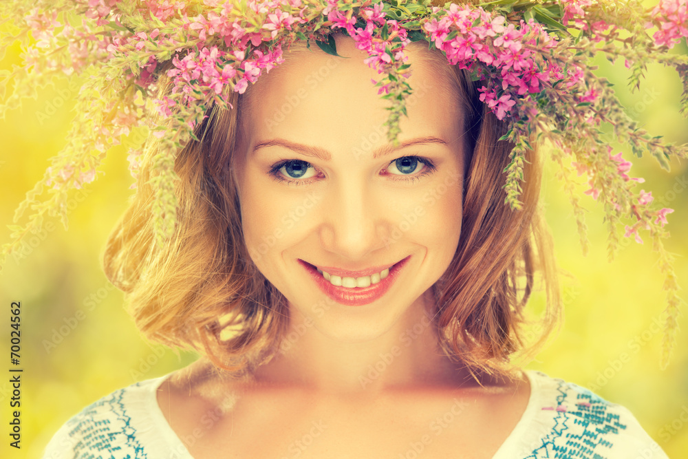 beautiful happy Slavic girl in a wreath of summer flowers beautiful happy Slavic girl in a wreath of summer flowers