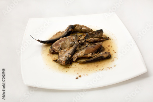 sprats on plate in oil on a white background