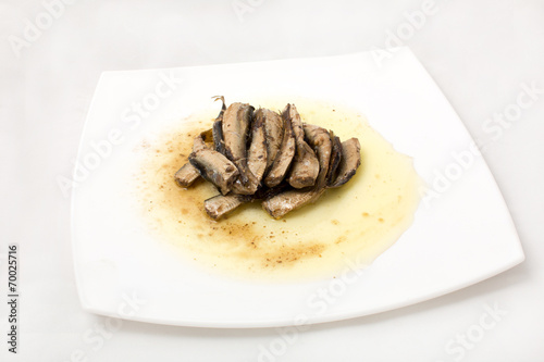 sprats on plate in oil on a white background