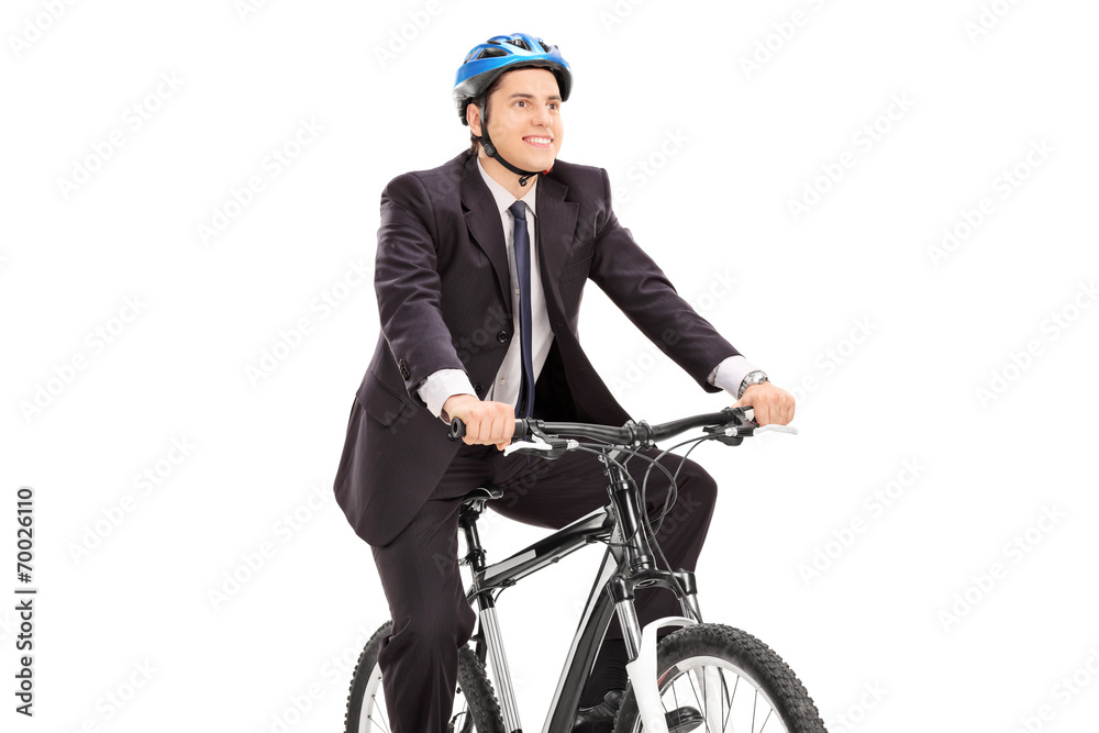 Fototapeta premium Young businessman riding a bicycle