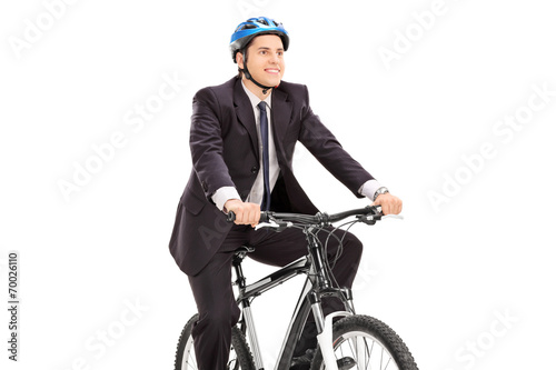 Young businessman riding a bicycle